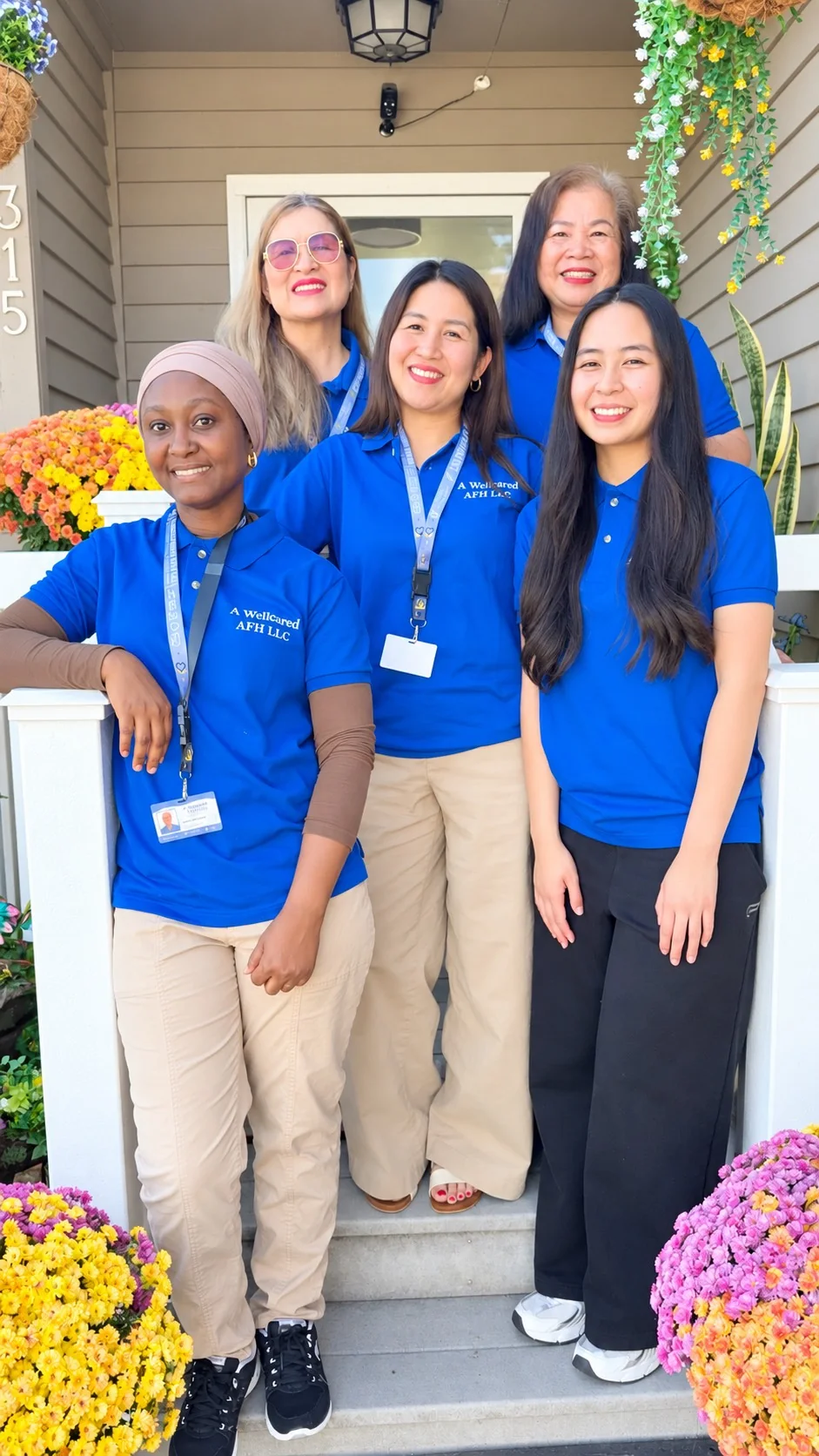 The caregiving team at A WellCared Adult Family Home, on the front steps of the home in Algona